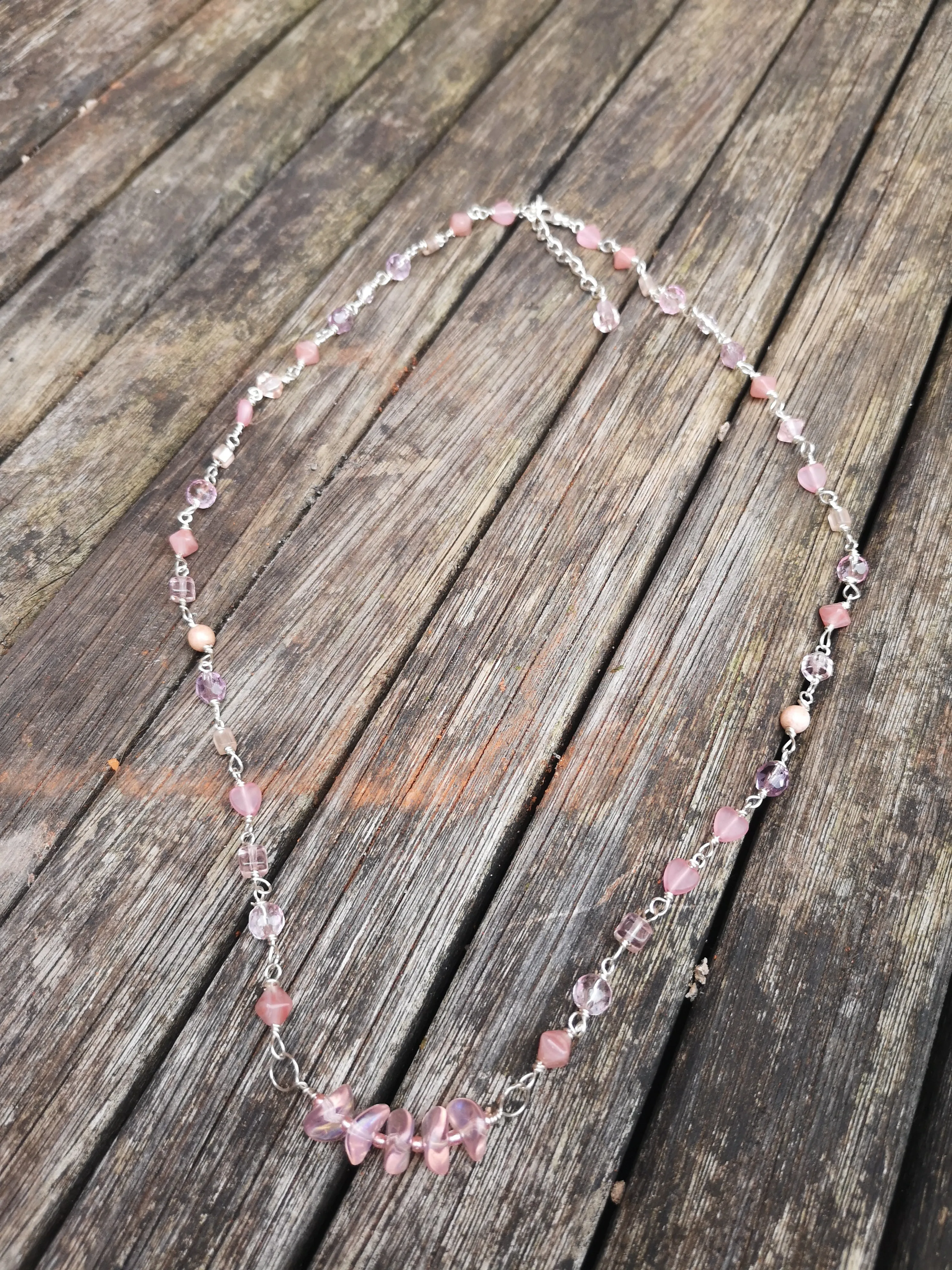 Cupid, pink crystals and glass beads  necklace with a dainty bar of wavy disc beads